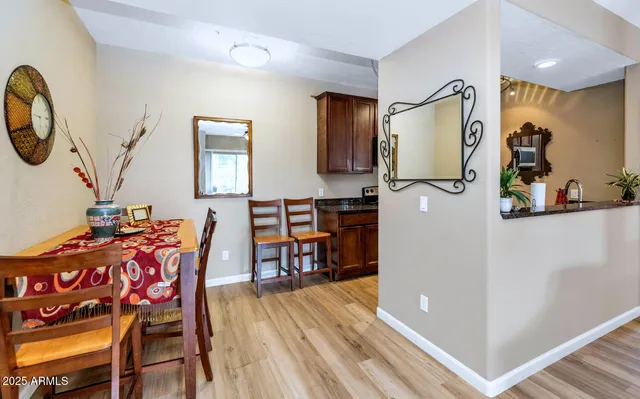 a view of a dining room with furniture and a chandelier