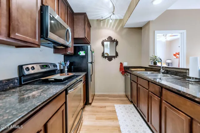 a kitchen with stainless steel appliances granite countertop a stove and a sink