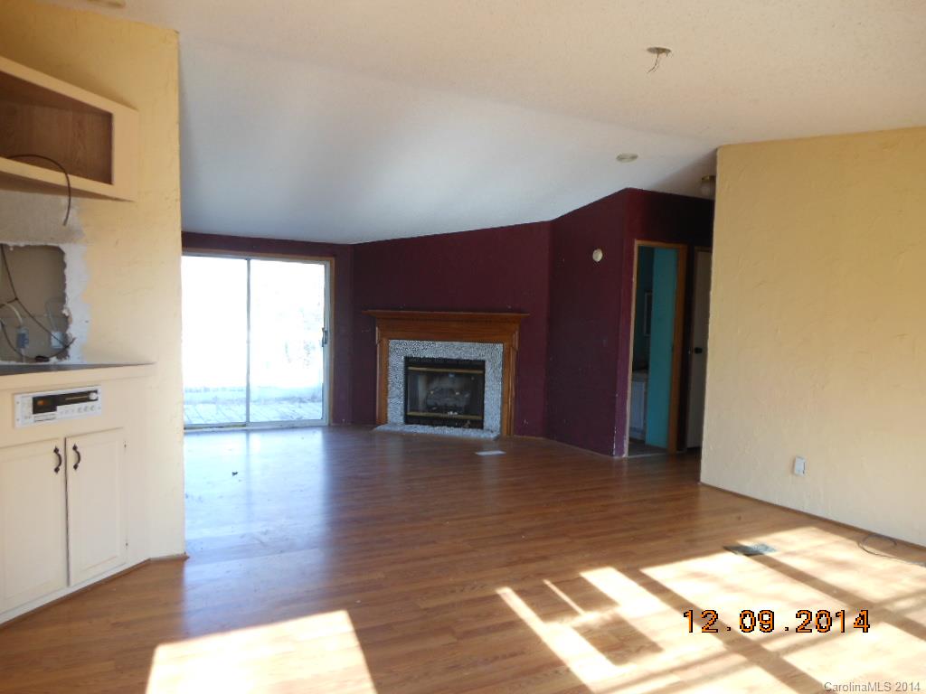 1808 Musselwhite Road Wingate, NC 28174 - Photo 5 of 16 a view of empty room with wooden floor and fireplace