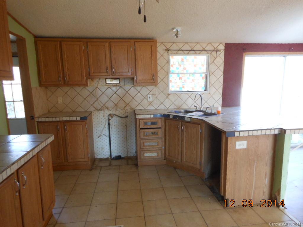 1808 Musselwhite Road Wingate, NC 28174 - Photo 6 of 16 a kitchen with stainless steel appliances granite countertop a sink and a stove