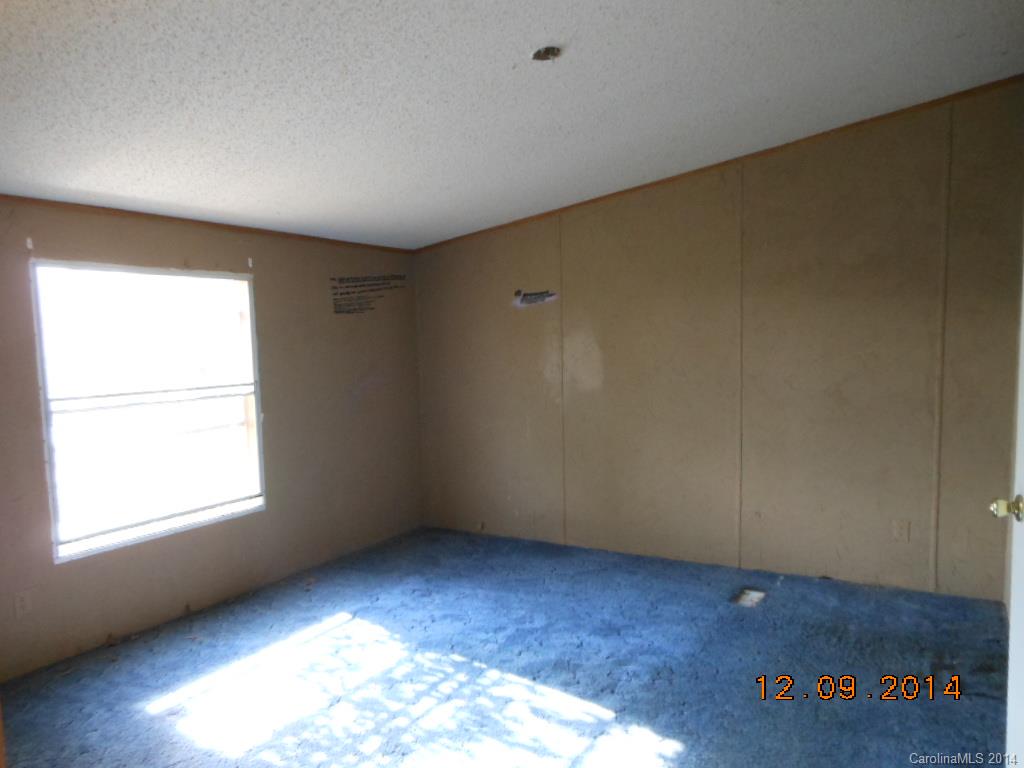 1808 Musselwhite Road Wingate, NC 28174 - Photo 9 of 16 an empty room with wooden floor and windows