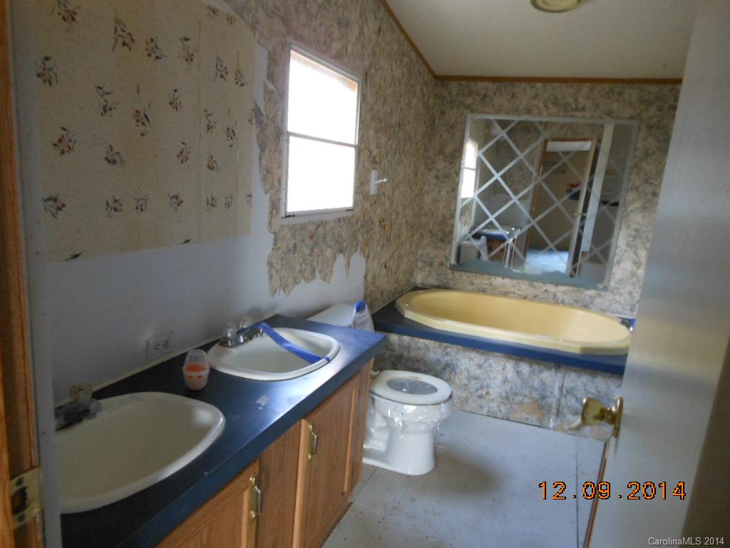 1808 Musselwhite Road Wingate, NC 28174 - Photo 10 of 16 a bathroom with a granite countertop sink and a mirror