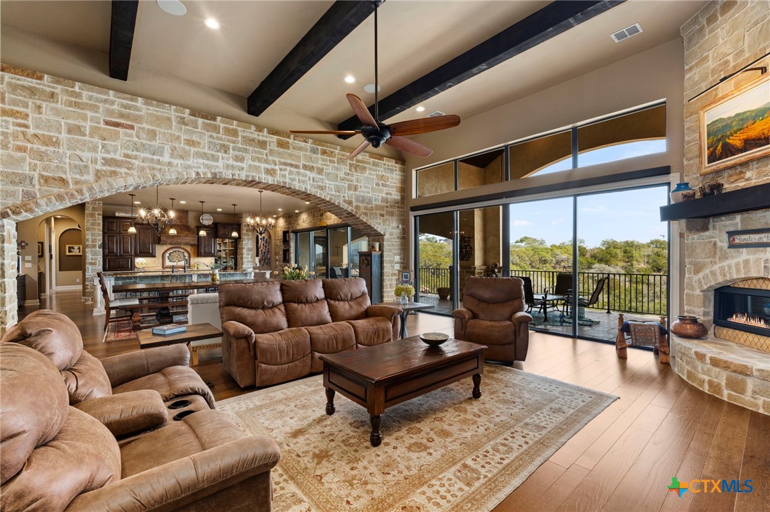 1039 Bluewater Place Spring Branch, TX 78070 - Photo 10 of 48 a living room with furniture a fireplace and a flat screen tv