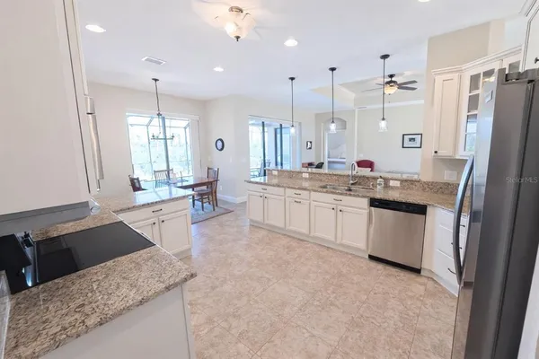 a large kitchen with a large window and stainless steel appliances