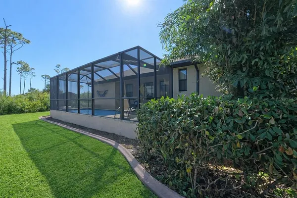 a view of a house with a yard and a garden