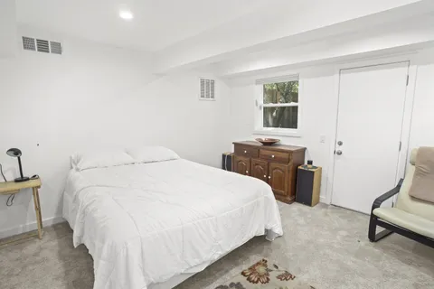 a bedroom with a bed and a chair