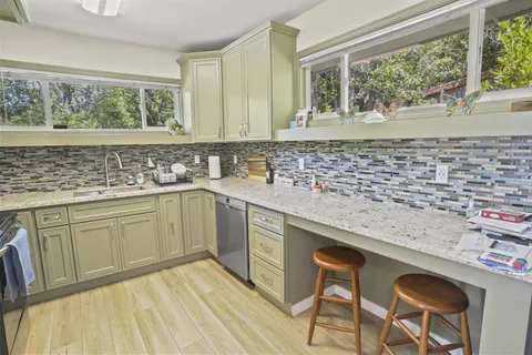 a kitchen with stainless steel appliances granite countertop a sink and cabinets