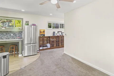 a view of a livingroom with furniture and a kitchen