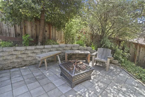 a view of a backyard with sitting area