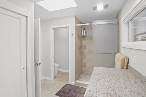 a bathroom with a shower and a mirror