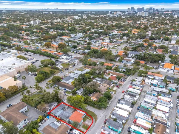 an aerial view of residential houses with city view
