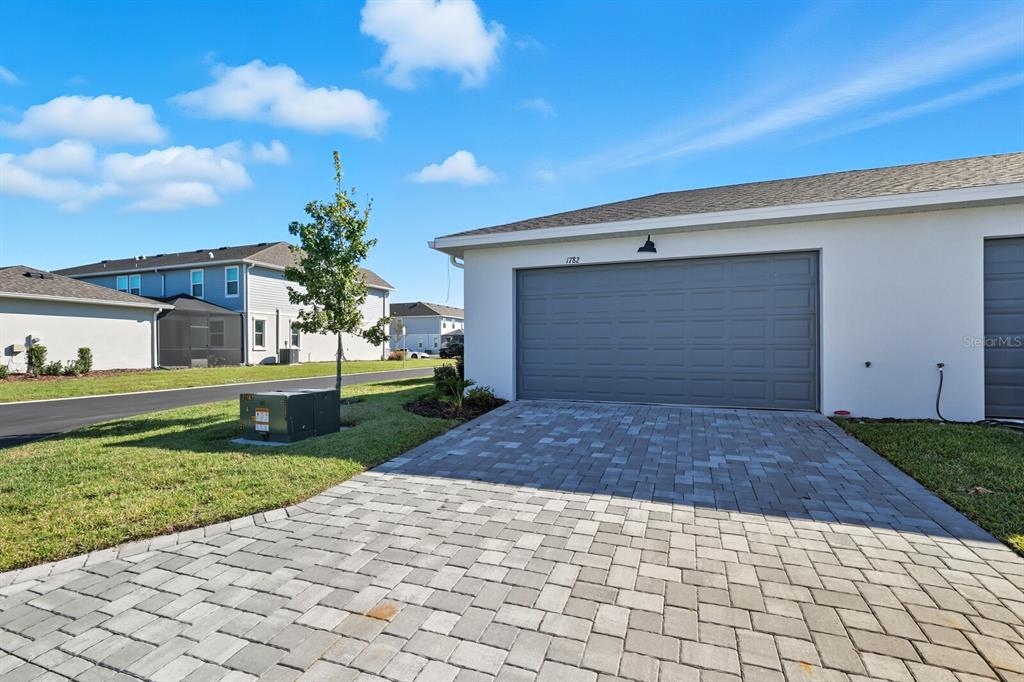 1782 Spreader Lane Sarasota, FL 34240 - Photo 2 of 38 a front view of a house with a yard and garage