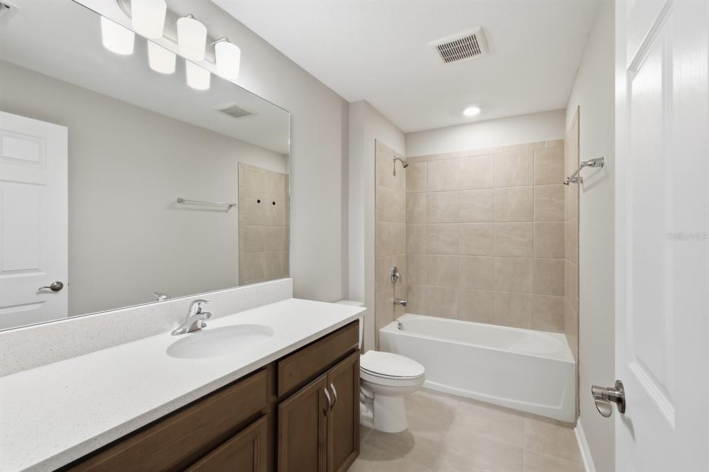 1782 Spreader Lane Sarasota, FL 34240 - Photo 21 of 38 a bathroom with a sink a toilet and shower