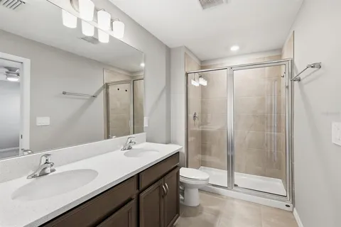 an empty room with fan and entrance