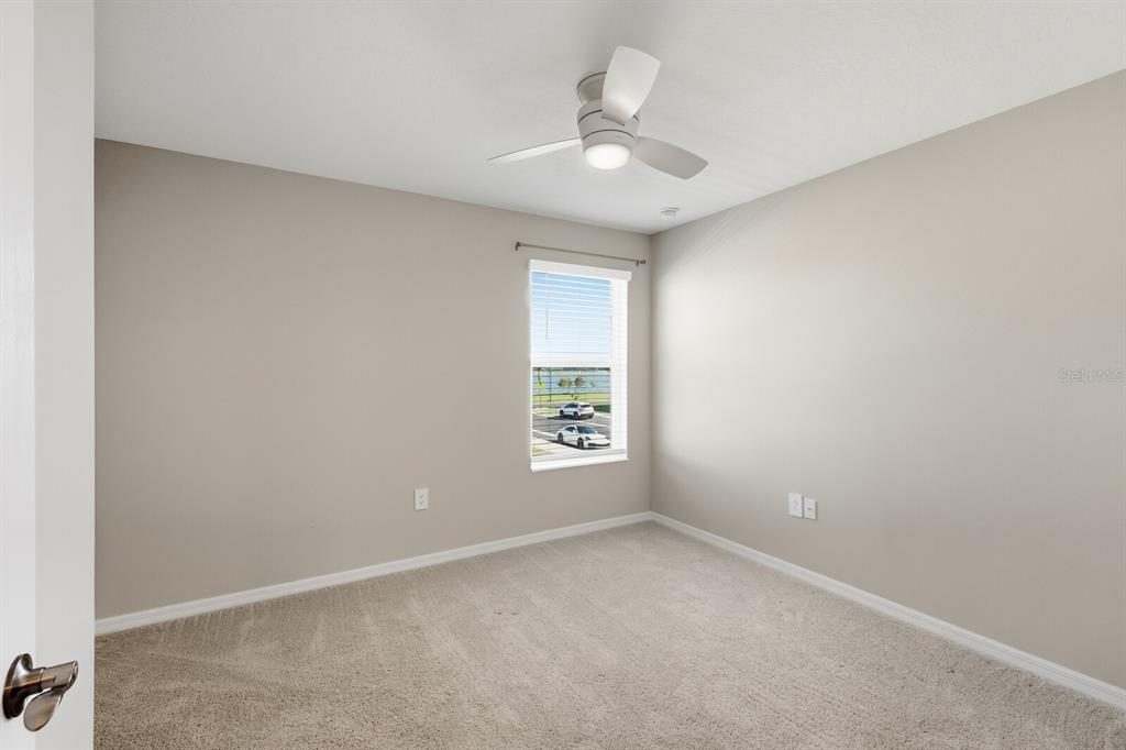 1782 Spreader Lane Sarasota, FL 34240 - Photo 23 of 38 an empty room with a window and a fan