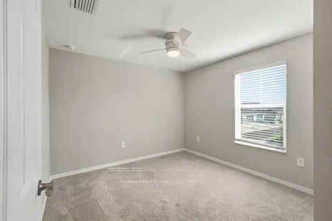 an empty room with a ceiling fan