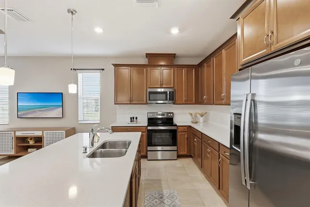 a kitchen with a table chairs stove and kitchen view