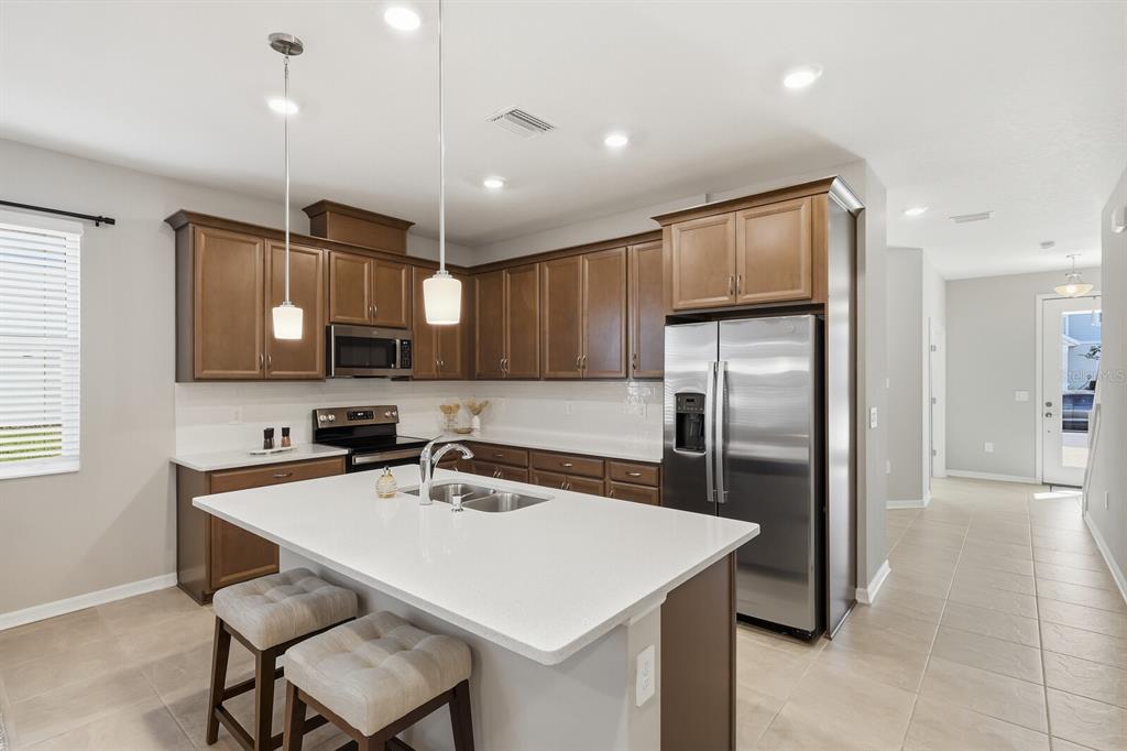 1782 Spreader Lane Sarasota, FL 34240 - Photo 5 of 38 a kitchen with granite countertop a sink appliances and refrigerator