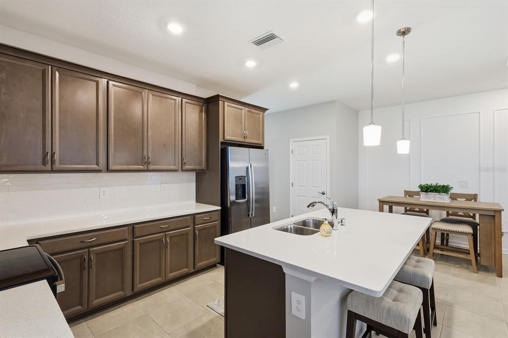 1782 Spreader Lane Sarasota, FL 34240 - Photo 8 of 38 a kitchen with a stove a refrigerator and a sink