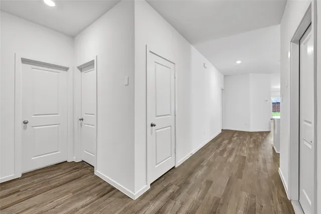 a view of a hallway with wooden floor