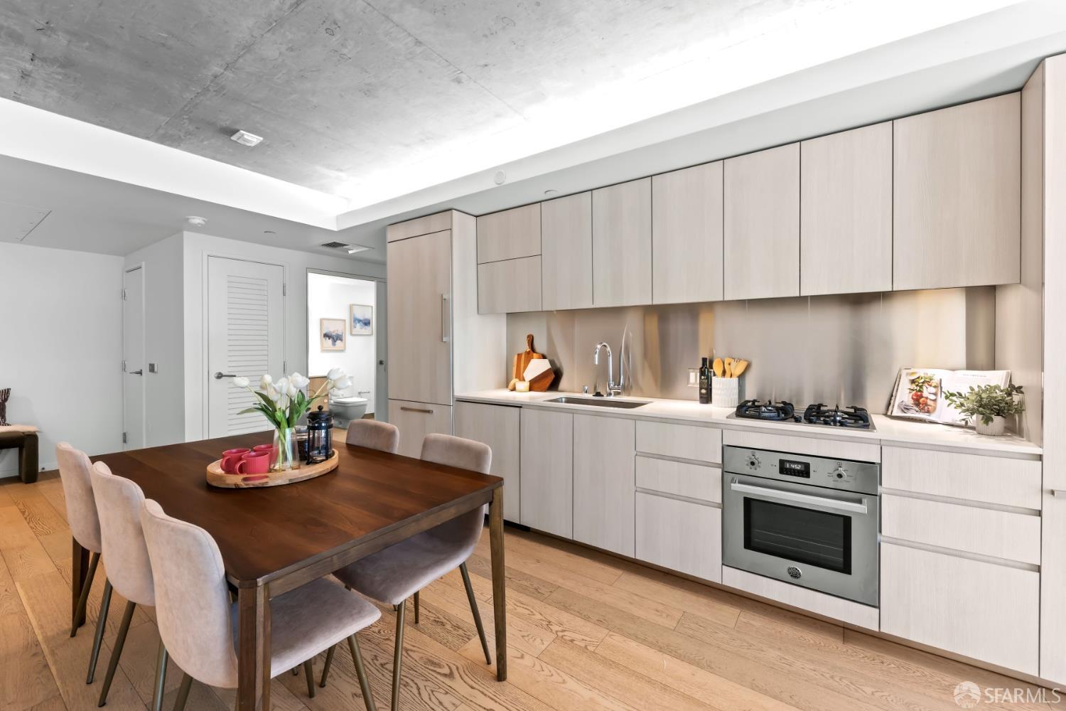 338 Potrero Avenue, Unit 206 San Francisco, CA 94103 - Photo 2 of 22 a kitchen with a white cabinets and stove top oven