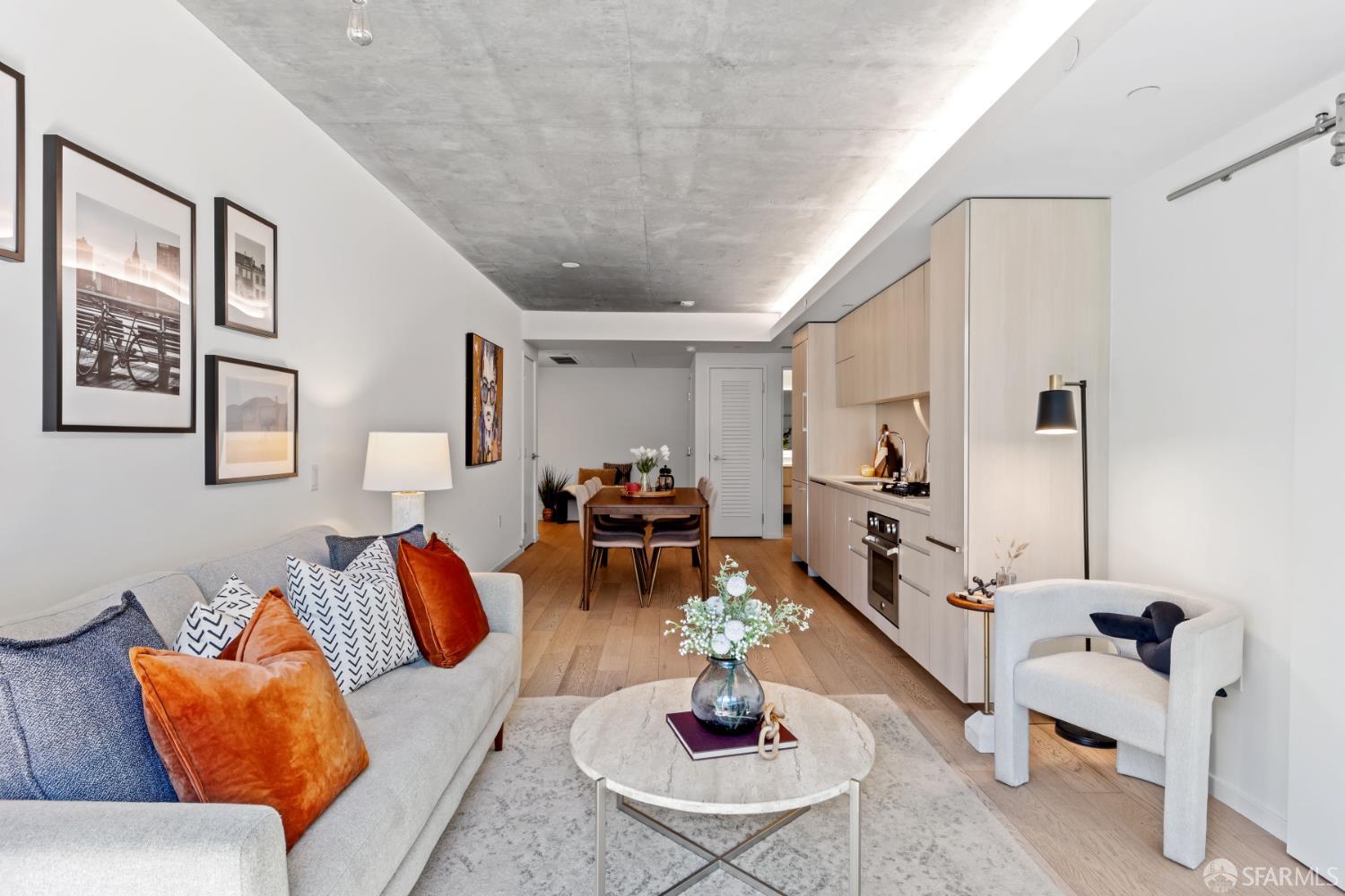 338 Potrero Avenue, Unit 206 San Francisco, CA 94103 - Photo 4 of 22 a living room with furniture and wooden floor