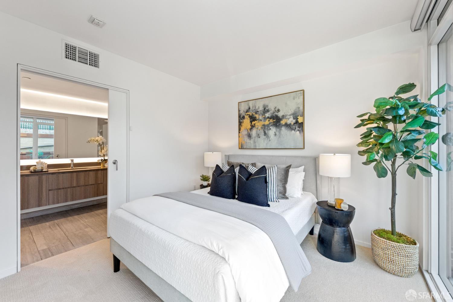 338 Potrero Avenue, Unit 206 San Francisco, CA 94103 - Photo 8 of 22 a bedroom with furniture and a potted plant