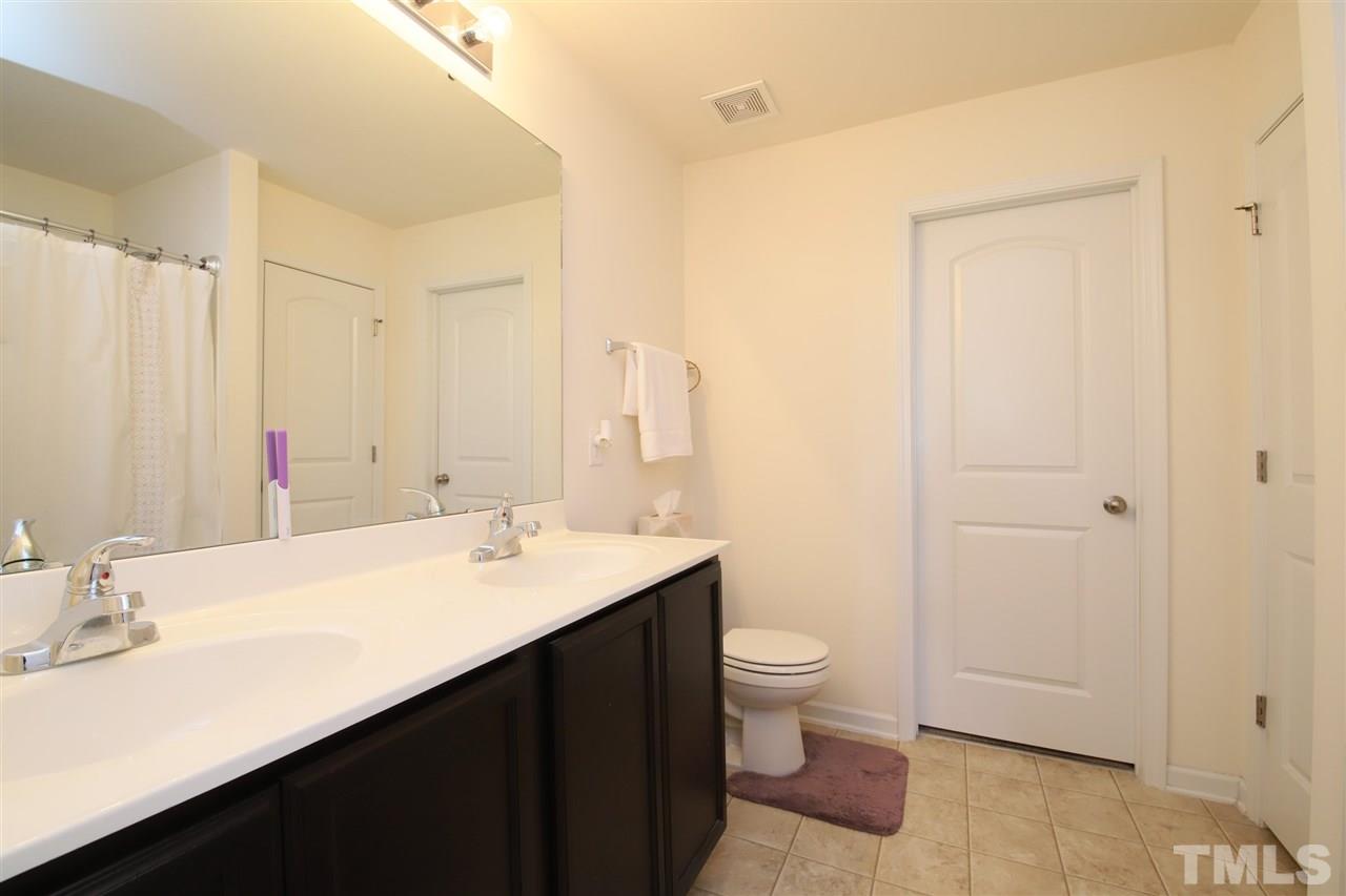 3453 Kernstown Drive Raleigh, NC 27610 - Photo 18 of 21 a bathroom with a sink a toilet and a mirror