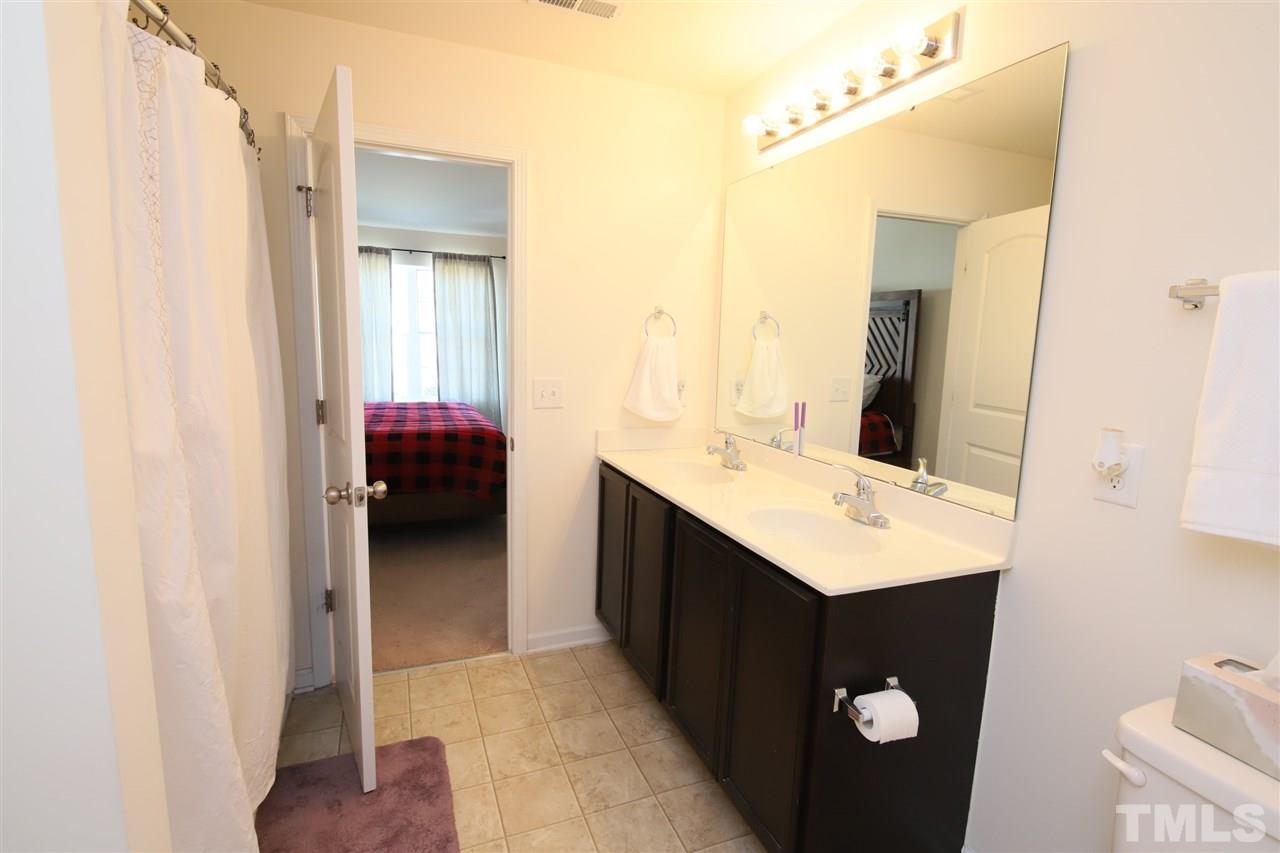 3453 Kernstown Drive Raleigh, NC 27610 - Photo 19 of 21 a en suite bathroom with a sink and a mirror