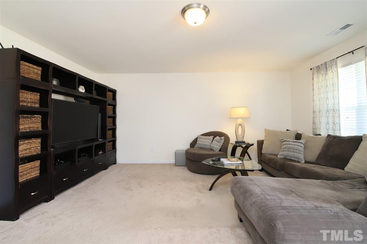 3453 Kernstown Drive Raleigh, NC 27610 - Photo 4 of 21 a living room with furniture and a flat screen tv