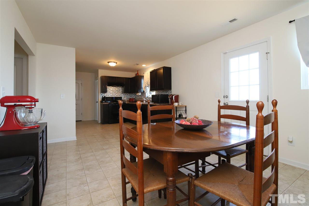 3453 Kernstown Drive Raleigh, NC 27610 - Photo 7 of 21 a view of a dining room with furniture and a window