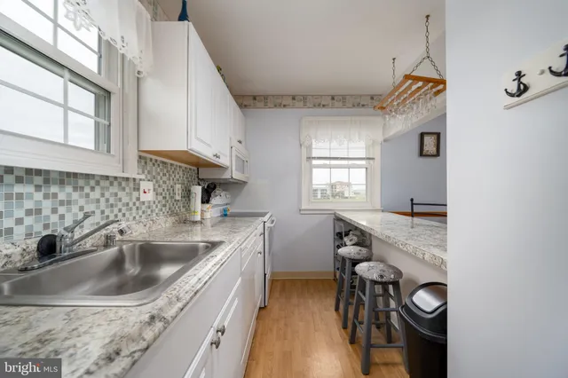 a kitchen with a sink cabinets and window