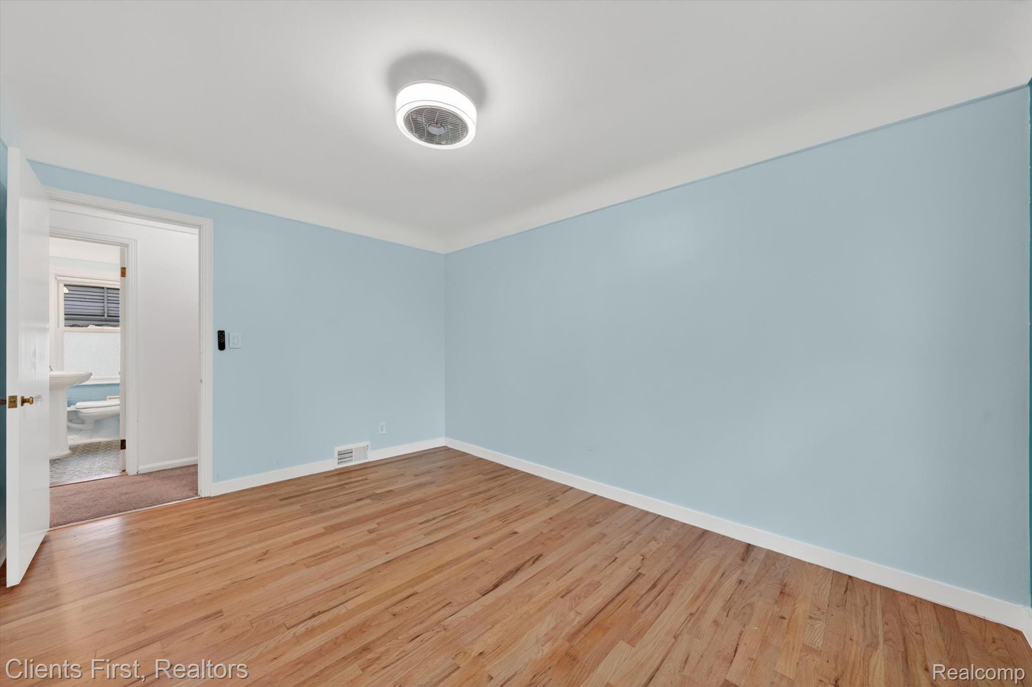 11000 Clinton River Road Sterling Heights, MI 48314 - Photo 21 of 33 Empty room featuring light wood-style flooring and baseboards