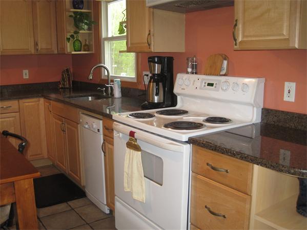 34 Kruse Road Hubbardston, MA 01452 - Photo 13 of 27 a kitchen with granite countertop a sink stove and cabinets