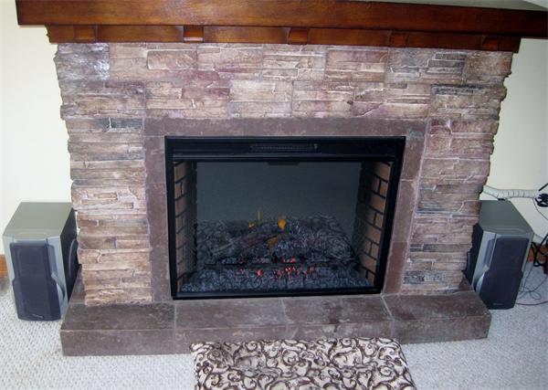 34 Kruse Road Hubbardston, MA 01452 - Photo 9 of 27 a stone fireplace with a clock on it