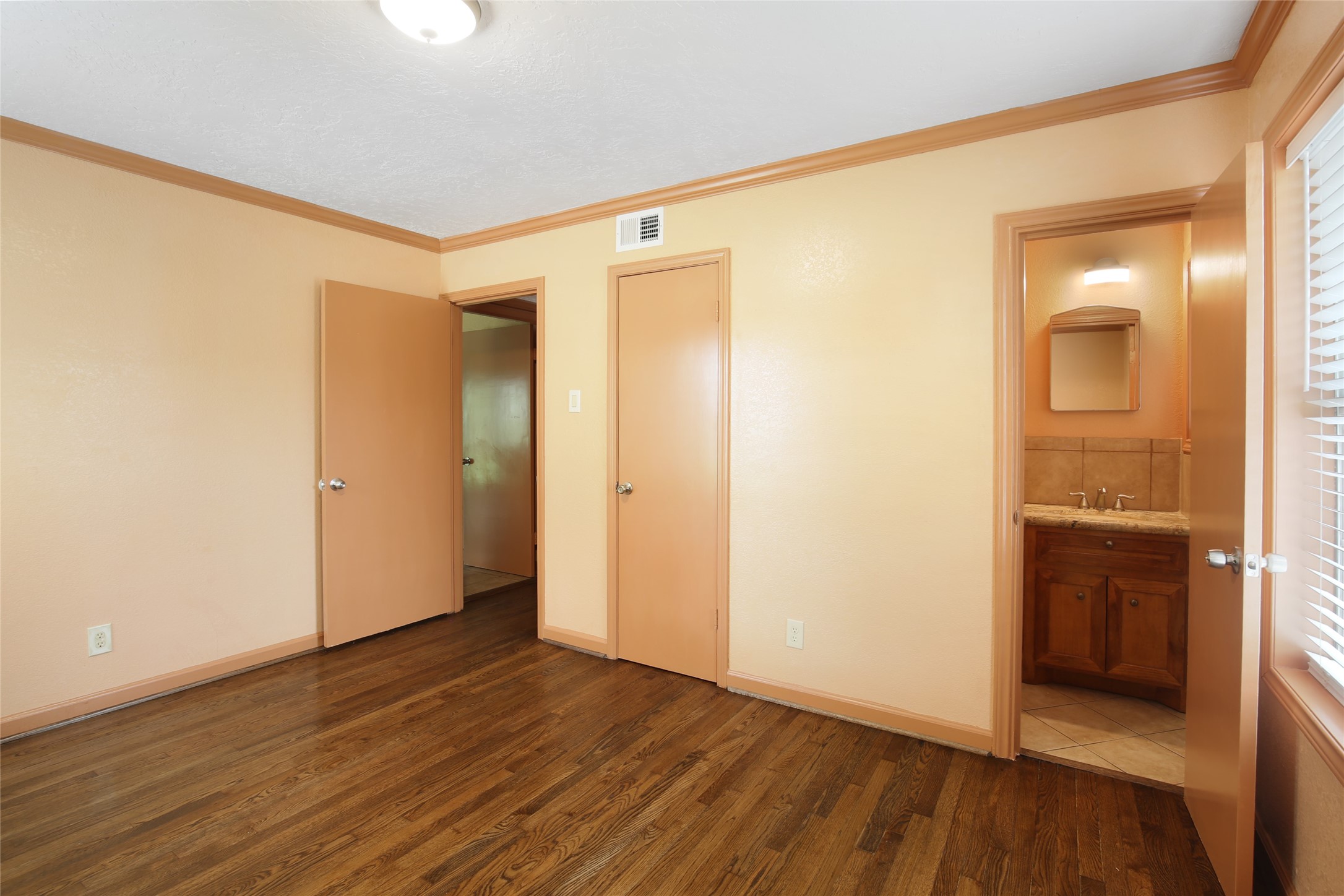 6923 Leader Street Houston, TX 77074 - Photo 8 of 19 an empty room with wooden floor and windows