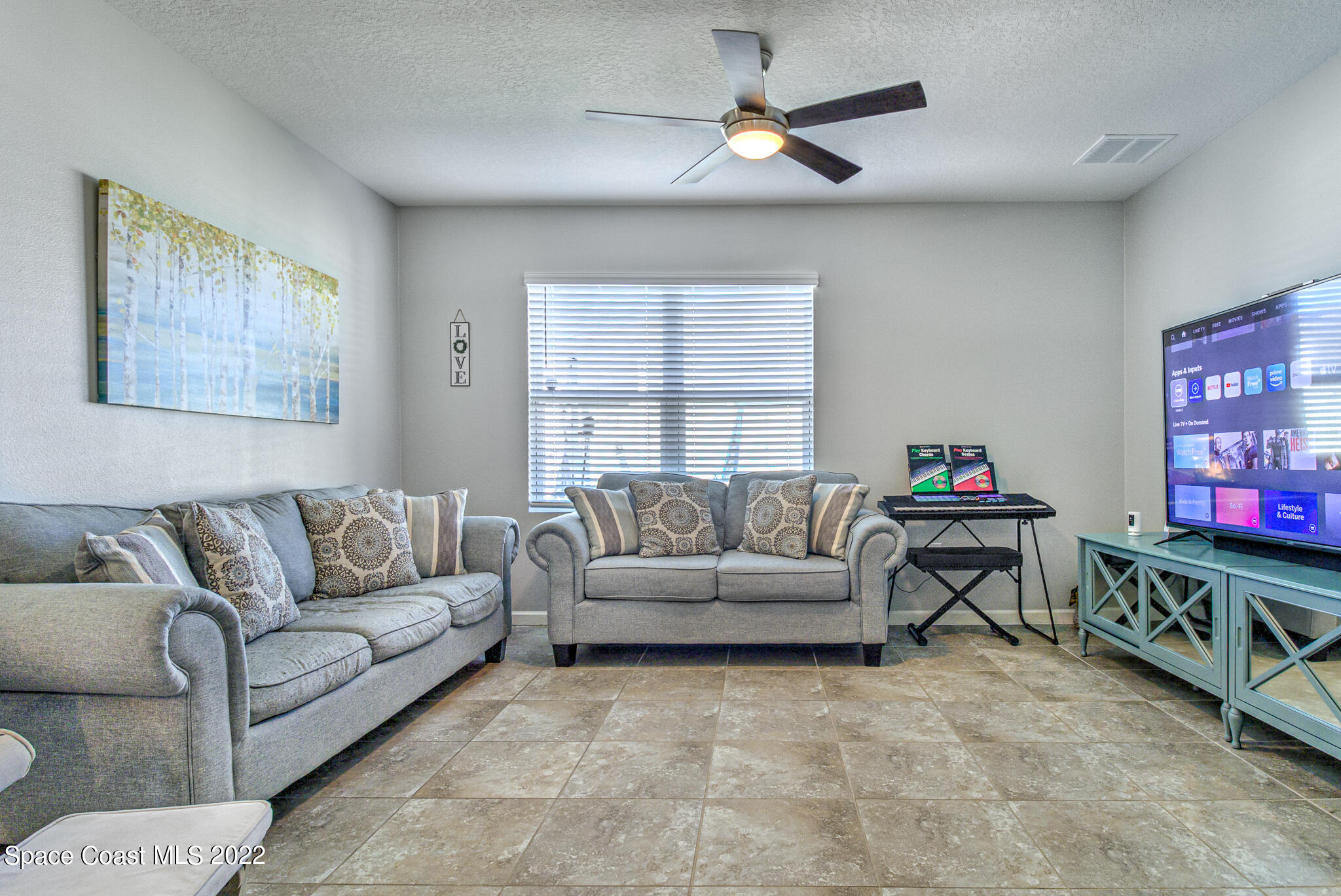 975 Newton Circle Rockledge, FL 32955 - Photo 11 of 30 a living room with furniture and a flat screen tv