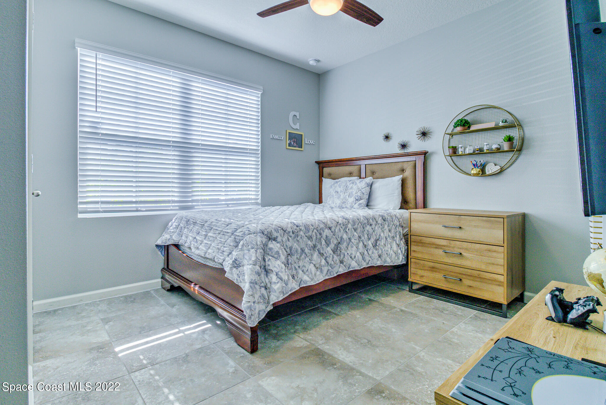 975 Newton Circle Rockledge, FL 32955 - Photo 12 of 30 a bedroom with a bed and a window