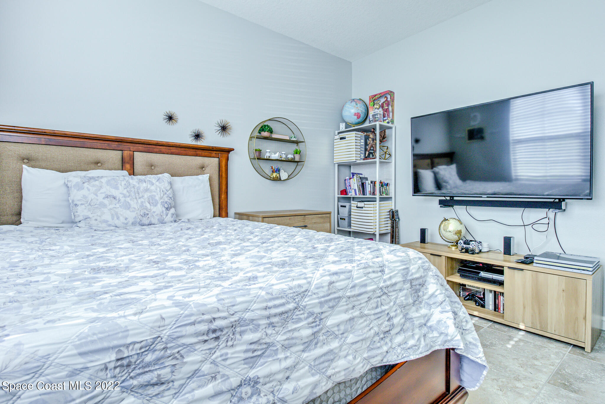 975 Newton Circle Rockledge, FL 32955 - Photo 13 of 30 a bedroom with a bed and dresser