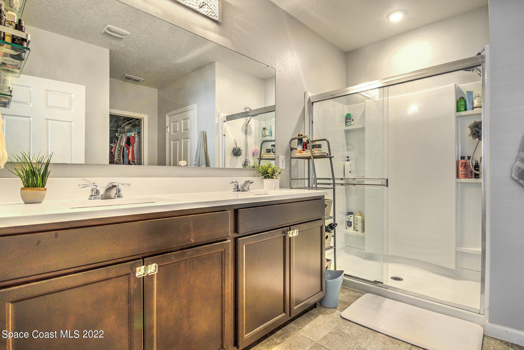 975 Newton Circle Rockledge, FL 32955 - Photo 14 of 30 a bathroom with a shower sink and mirror
