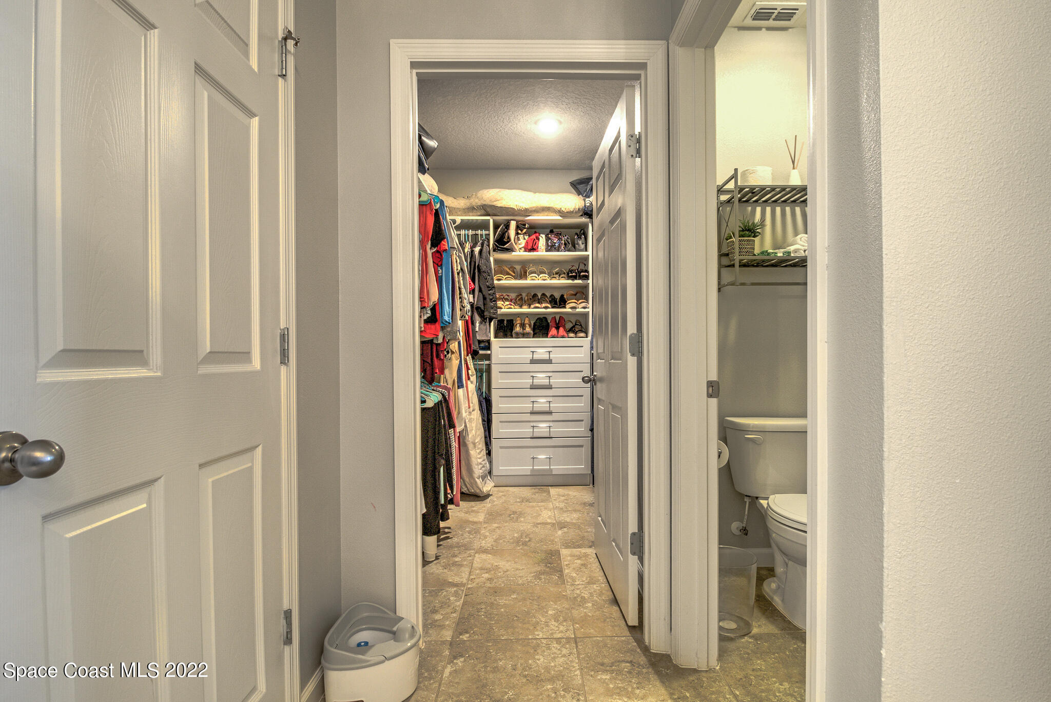 975 Newton Circle Rockledge, FL 32955 - Photo 15 of 30 a view of a hallway with wooden shelves