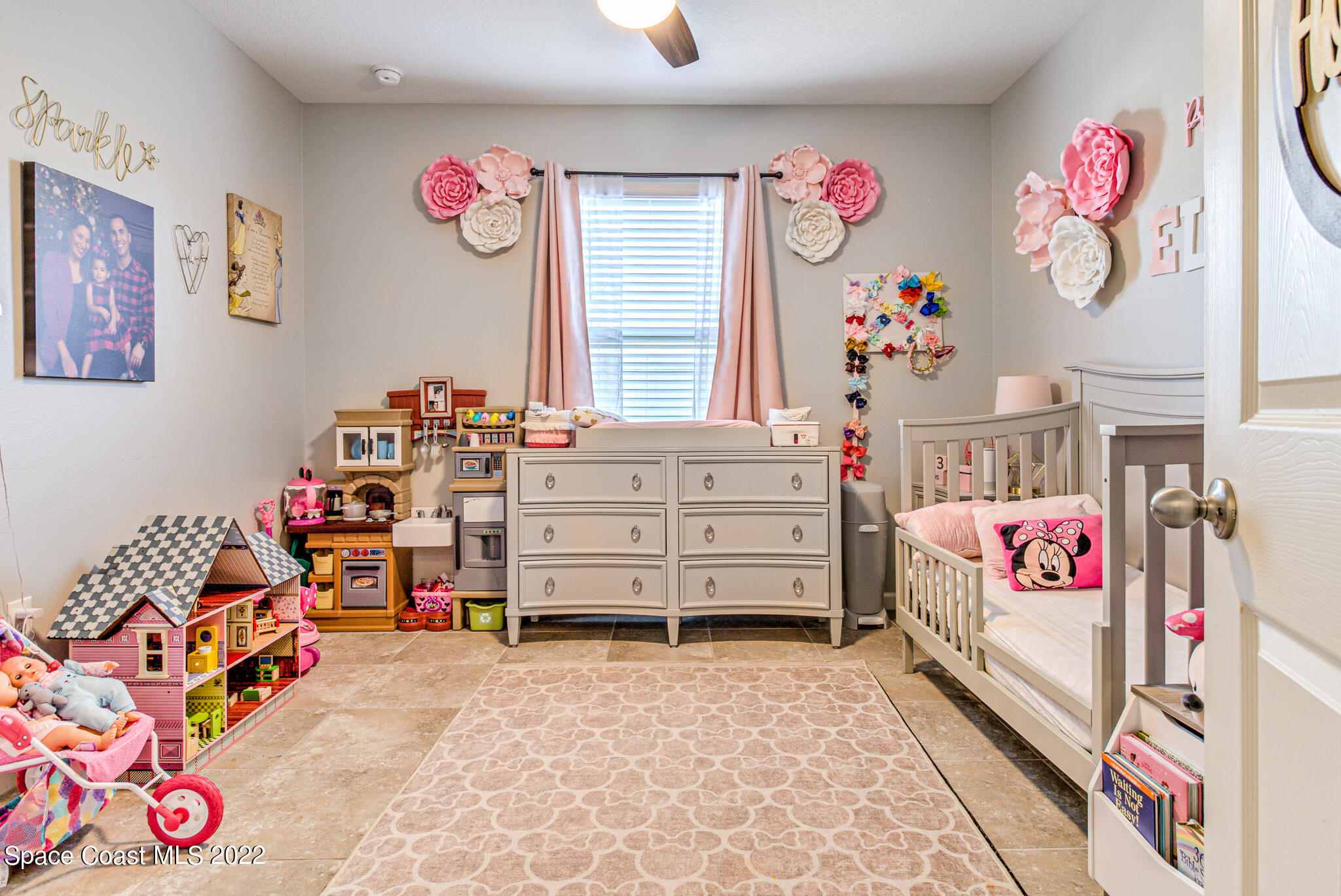 975 Newton Circle Rockledge, FL 32955 - Photo 16 of 30 a bedroom with toys and a bed