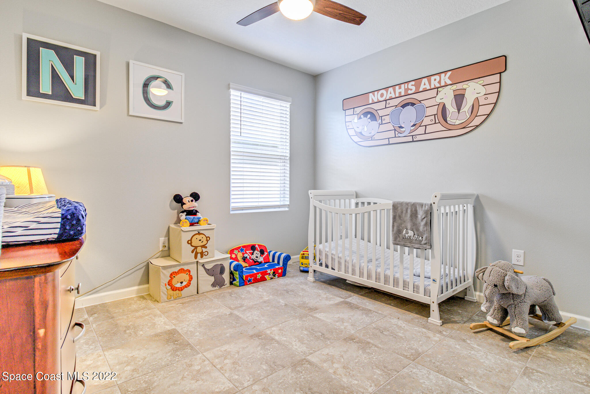 975 Newton Circle Rockledge, FL 32955 - Photo 18 of 30 a bedroom with baby toys and a chandelier