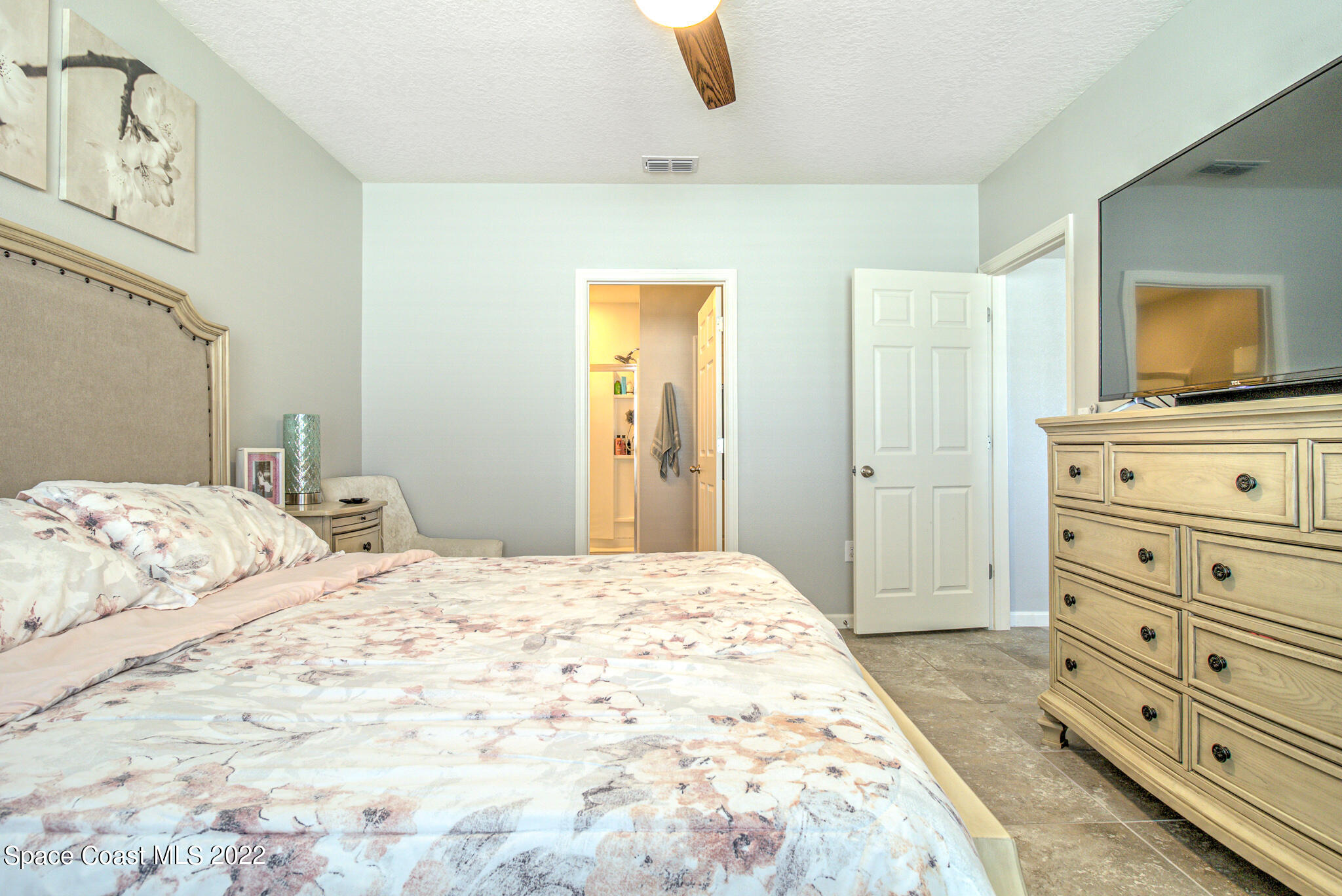 975 Newton Circle Rockledge, FL 32955 - Photo 21 of 30 a bedroom with a bed and a dresser