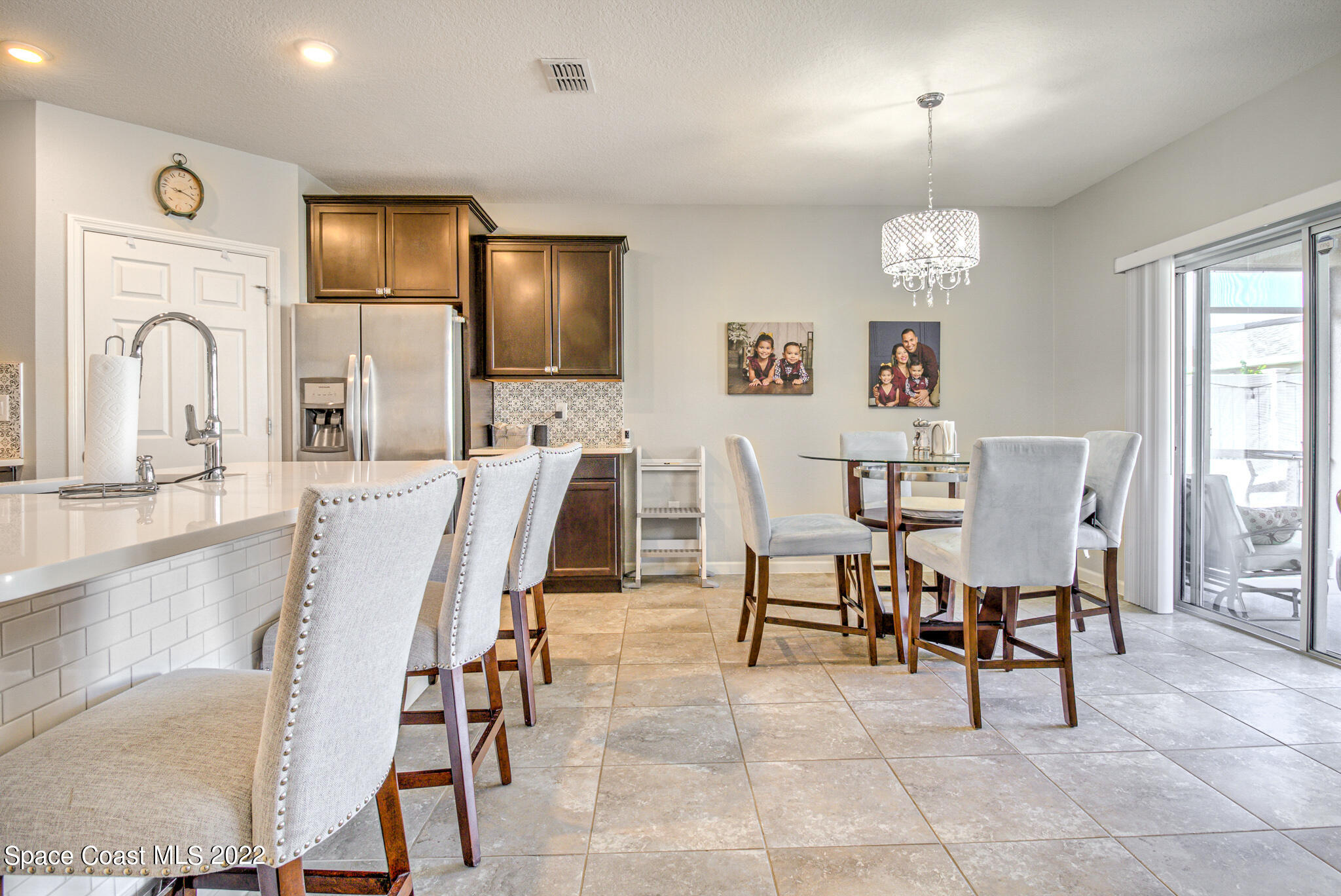 975 Newton Circle Rockledge, FL 32955 - Photo 6 of 30 a view of a dining room with furniture and chandelier