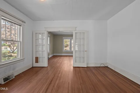 wooden floor in an empty room with a window
