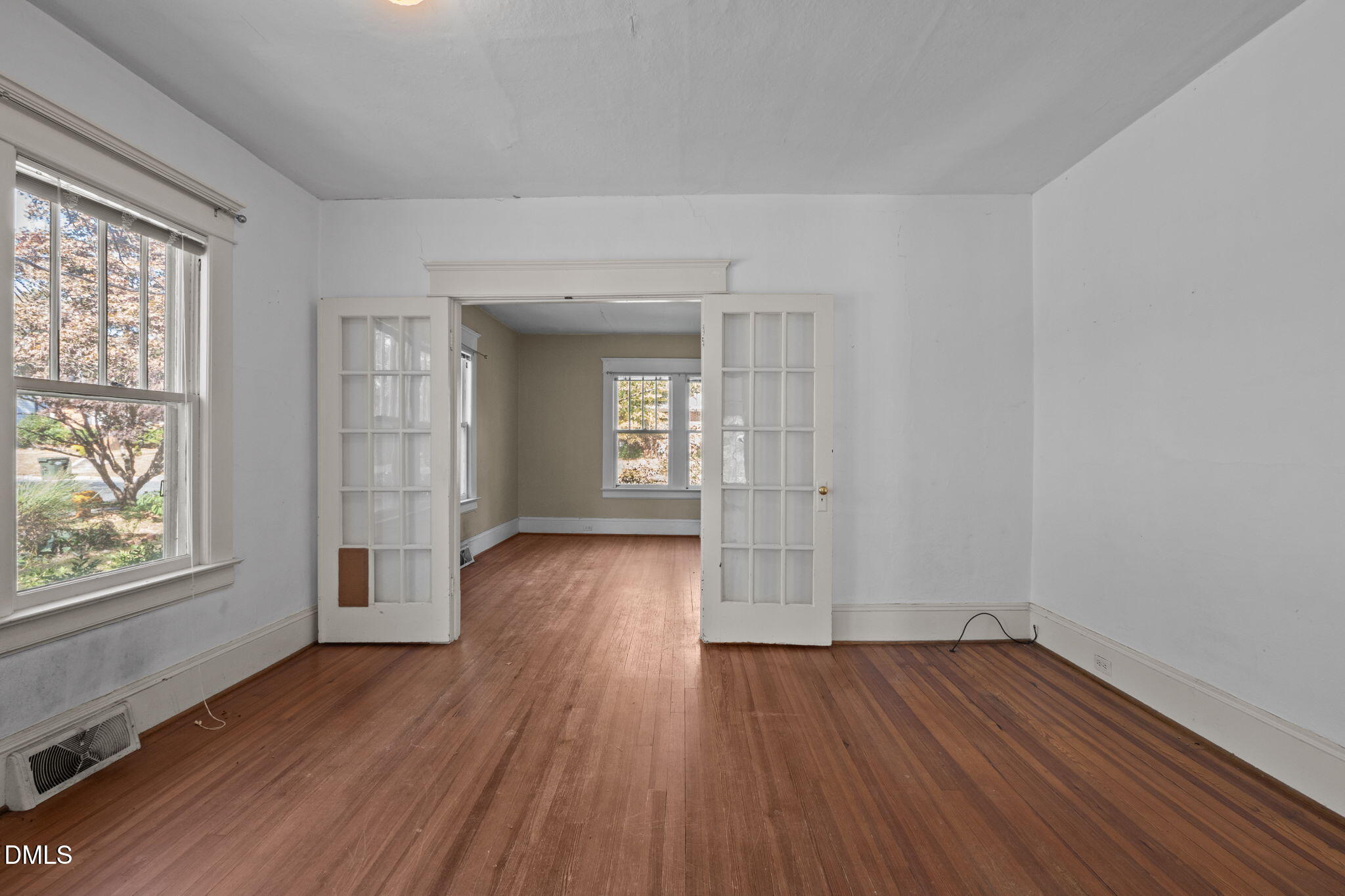 303 Clark Street Durham, NC 27701 - Photo 11 of 30 wooden floor in an empty room with a window