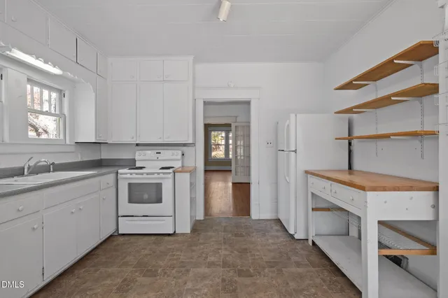 a kitchen with a stove oven and sink