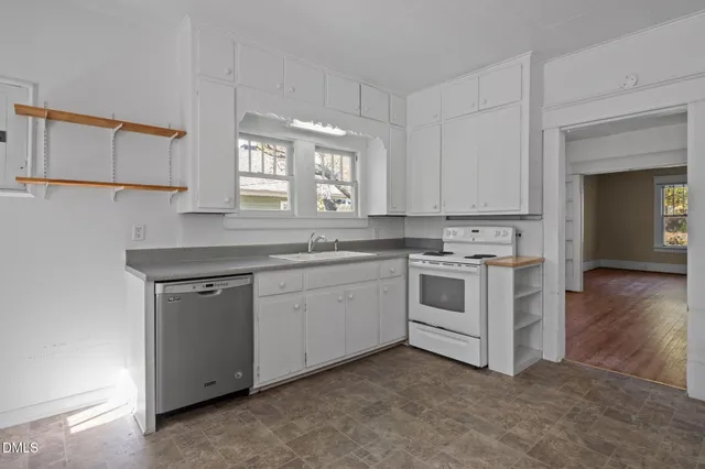 a white kitchen with a stove top oven