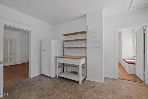 a view of an empty room and fire place